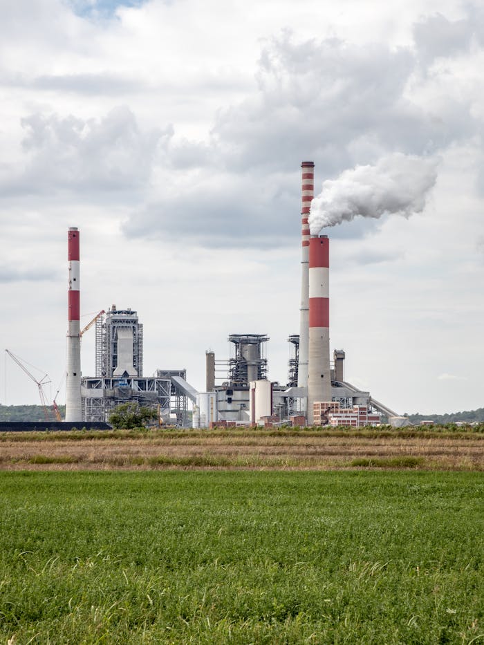 A power plant with smokestacks releasing smoke, highlighting industrial pollution and energy production.